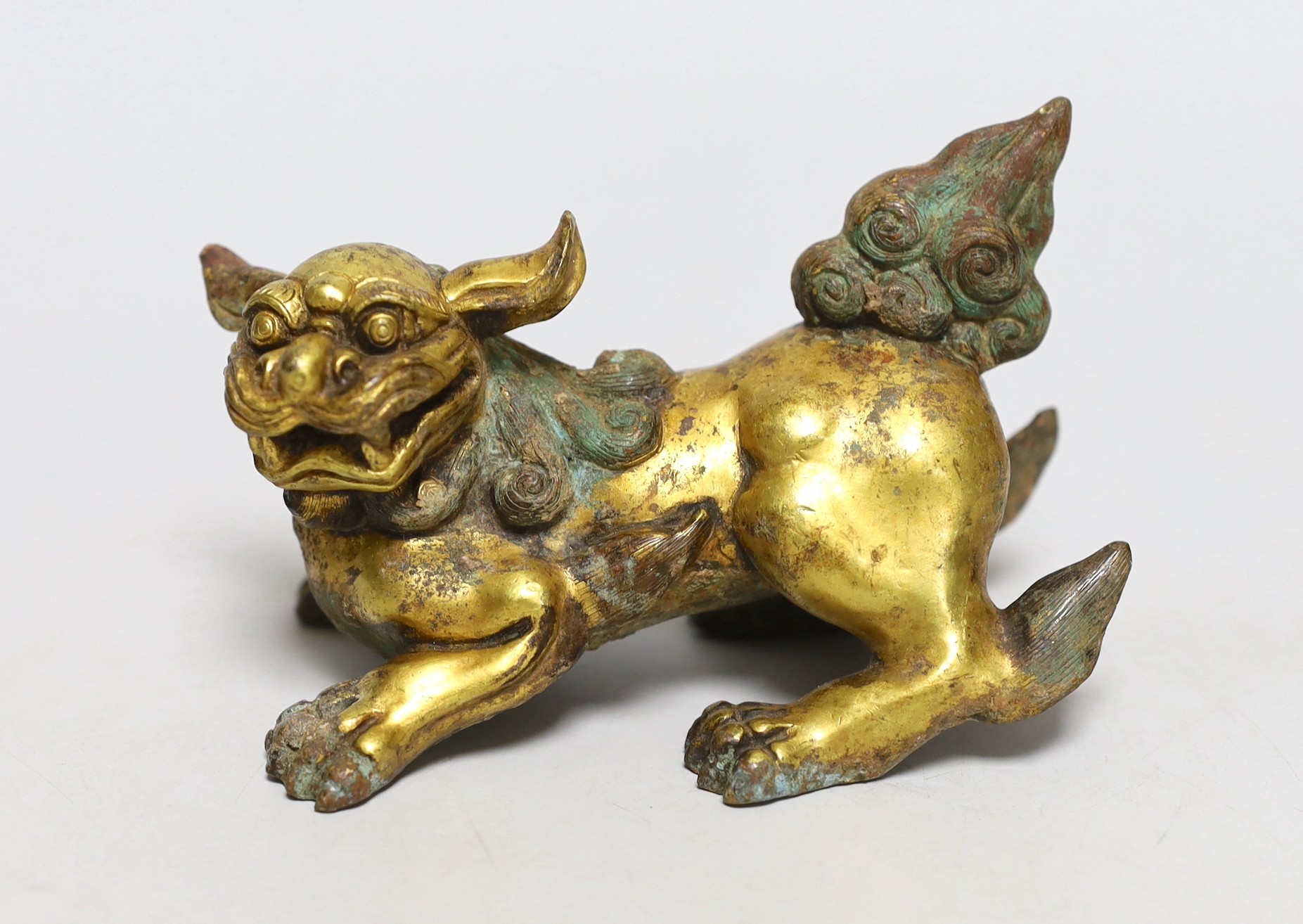 A Chinese gilt bronze figure of a lion dog, Han or later, 13cm wide